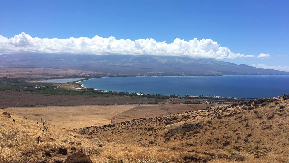aerial overview of Lahaina Pali Trail at sunset behind water in Maui, Hawaii, USA